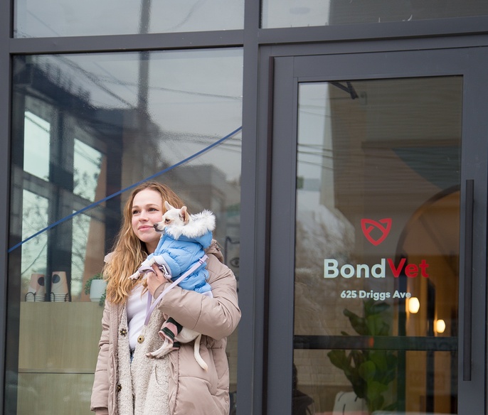 Pet parent outside clinic lobby